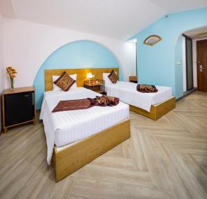 Postel nebo postele na pokoji v ubytování Prime New Hotel