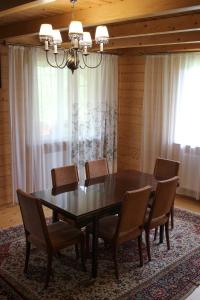 a dining room table with chairs and a chandelier at Чорногірський Вітер in Verkhovyna