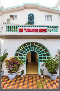 a building with a sign that reads the turkish house at THE TURQUOIISE HOUSE in Morjim