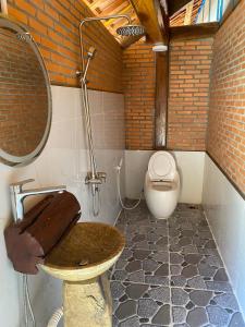 a bathroom with a toilet and a sink in it at Floor river view in Cat Tien