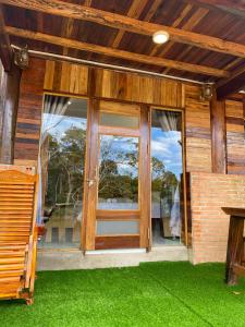 a sliding glass door on a house with green grass at Floor river view in Cat Tien