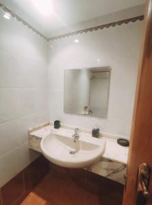 a white bathroom with a sink and a mirror at Double Room with bathroom in Alicante
