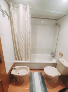 a bathroom with a toilet and a sink and a tub at Double Room with bathroom in Alicante