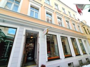 a building with a sign on the front of it at Gleznotaju Old Town Two Bedroom Apartment in Rīga