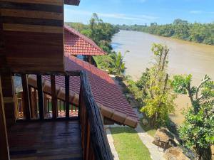a house with a balcony with a river in the background at Floor river view in Cat Tien