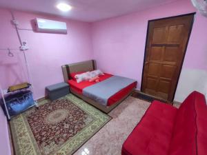 a small room with a bed and a door at Pink Homestay D'Perlis in Kangar