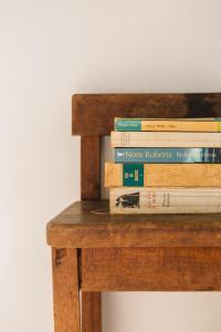 a pile of books sitting on top of a wooden table at Campanha Apartment By Porto Stories in Porto