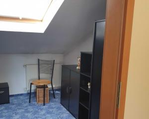 a room with a desk and a chair and a cabinet at Ferienwohnung Wilke in Garz-Usedom