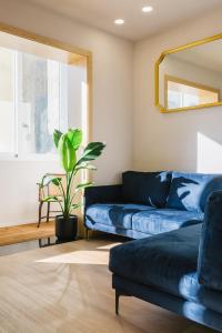 a living room with a blue couch and a plant at Campanha Apartment By Porto Stories in Porto