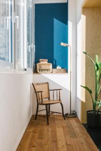 a chair in a room with a table and a window at Campanha Apartment By Porto Stories in Porto