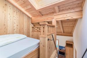 a tiny house with a bed and a ladder at Guntschöllerhof Rotwand in Fiè +18 photos
