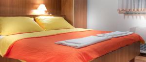 a bed with two towels sitting on top of it at Apartment in Novalja with sea view, terrace, air conditioning, WiFi 3565-1 in Novalja