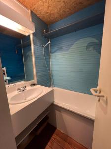 a bathroom with a sink and a mirror at Val Thorens Condo in Val Thorens