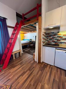 a room with a loft bed and a kitchen at Val Thorens Condo in Val Thorens