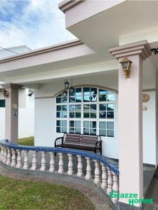 a bench on the porch of a house at Ipoh Town Bangalow Canning Garden Football Table in Ipoh