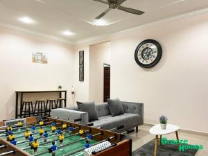 a living room with a foos ball in the middle of a table at Ipoh Town Bangalow Canning Garden Football Table in Ipoh