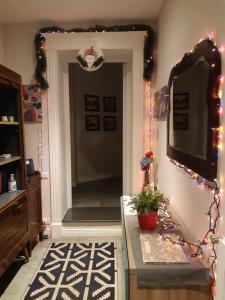 a living room with a television and christmas lights at La casa di FLO in Naples