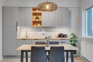 a kitchen with a wooden table and chairs at Sunny Central Apartment in Reykjavík