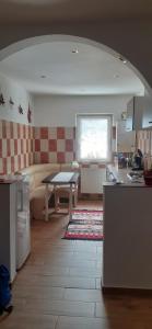 a kitchen and living room with a table and a couch at Apartament 2 cam Predeal in Predeal