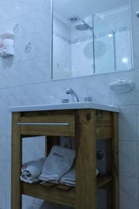 Hotel Ychoalay Caz في ريكونكيستا: حمام مع حوض ومكتب مع المناشف