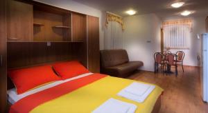 a bedroom with a colorful bed and a chair at Studio apartment in Novalja with sea view, terrace, air conditioning, WiFi 3565-8 in Novalja