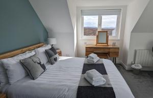 a bedroom with a bed with towels on it at Ruadh in Ose +41 photos