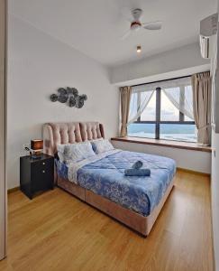 a bedroom with a bed and a large window at Royal Strand, Country Garden Danga Bay Homestay by WELCOME HOME in Johor Bahru