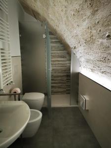 a bathroom with a shower and a toilet and a sink at President House Matera in Matera