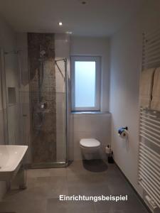 een badkamer met een douche, een toilet en een raam bij Hof Schütterle in Friedrichshafen