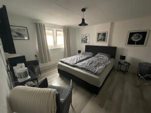 a bedroom with a bed and a chair in it at Pension Auberge de Dael in Valkenburg