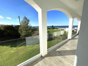a balcony with a view of the ocean at White House studio with sea view and parking in Polis Chrysochous