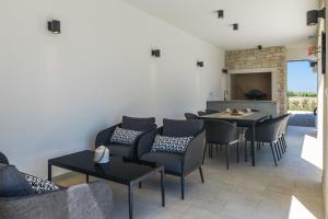 a dining room with chairs and a table at Villa Bella and Chiara by SeeAdria Agency in Brtonigla