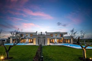 a large house with a yard with a pool at Villa Bella and Chiara by SeeAdria Agency in Brtonigla