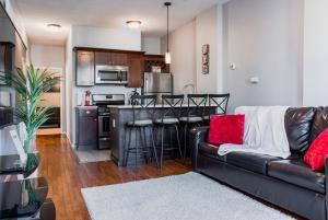 a living room with a couch and a kitchen at Lovely 2BR apartment by Wooster Square- great neighborhood in New Haven