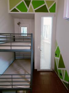 a room with two bunk beds and a door at Garden House in Florence