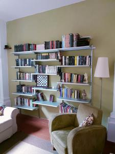 a living room with a book shelf filled with books at Garden House in Florence