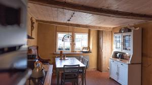 a kitchen with a table and chairs and a refrigerator at Haus Krauterkasten in Naumburg