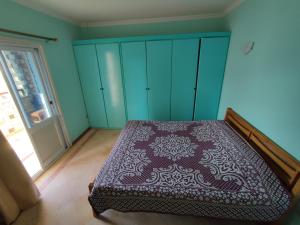 a bedroom with a bed and blue cabinets and a door at Farsha View in Sharm El Sheikh