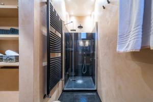 a bathroom with a shower with a glass shower stall at Urban Retreat in Florence