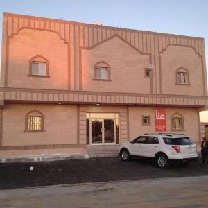 a white car parked in front of a building at Hana Yanbu Hotel Apartments in Yanbu