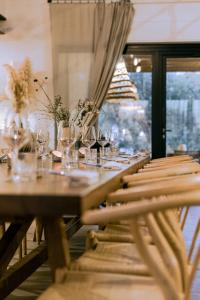 a long wooden table with wine glasses on it at Santa Lucia Maccarese - Residenza Agricola in Maccarese
