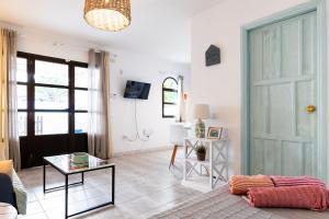 a living room with a door and a table at Casa Piquel in Corralejo