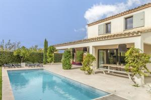 una piscina di fronte a una casa di Les Cerisiers du Mont Ventoux a Malaucène