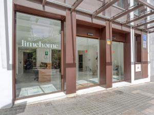 a store front with glass windows on a street at limehome Barcelona Carrer de Fontcoberta - Digital Access in Barcelona