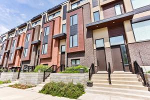 a row of apartment buildings with stairs in front at 3bdr townhouse in Downsview Park - Free parking - 25 min to Downtown in Toronto