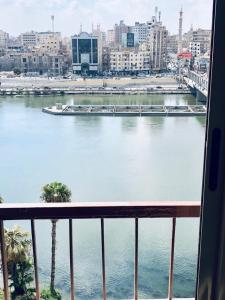 a view of a river from a balcony of a city at شقة فندقية مميزة بالمنصورة in Ṭalkha