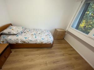 a small bedroom with a bed and a window at 4 pièces avec parking à 2 min du centre commercial et du lac de Créteil in Créteil