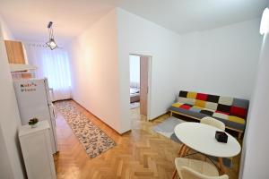 a small living room with a table and a couch at FLH - Kaly's Place in Sibiu