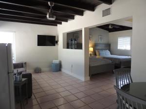 a living room with two beds and a tv in a room at Sands of Islamorada in Islamorada