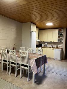 a kitchen with a table and chairs and a refrigerator at Tilava huoneisto in Saarijärvi